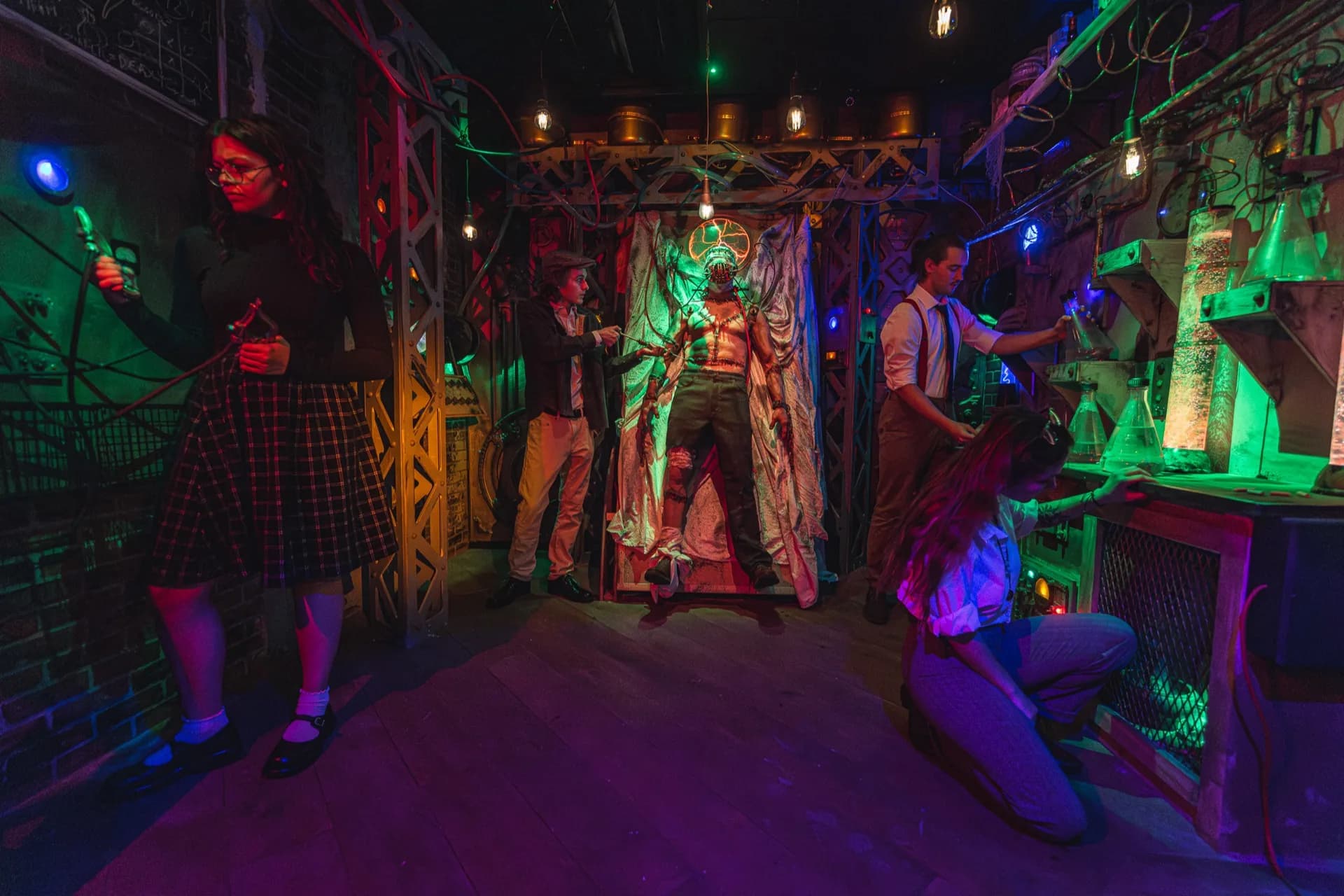 Players engaged in a themed escape room with colorful lighting.