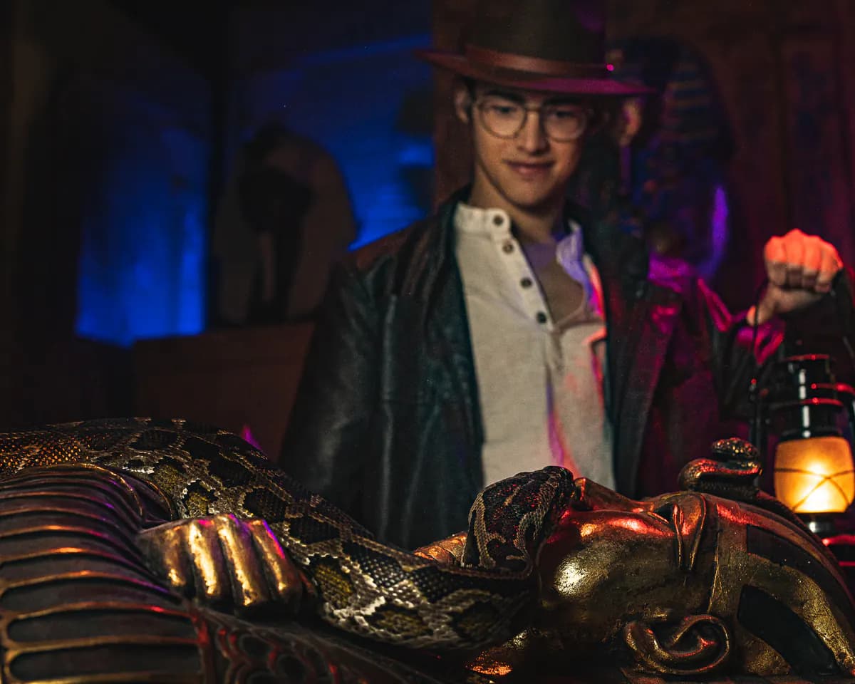 A player interacts with a snake and a golden statue.